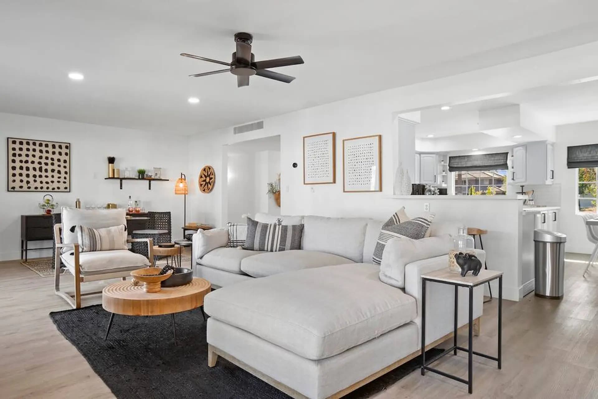 image of woman on phone working on her laptop smiling